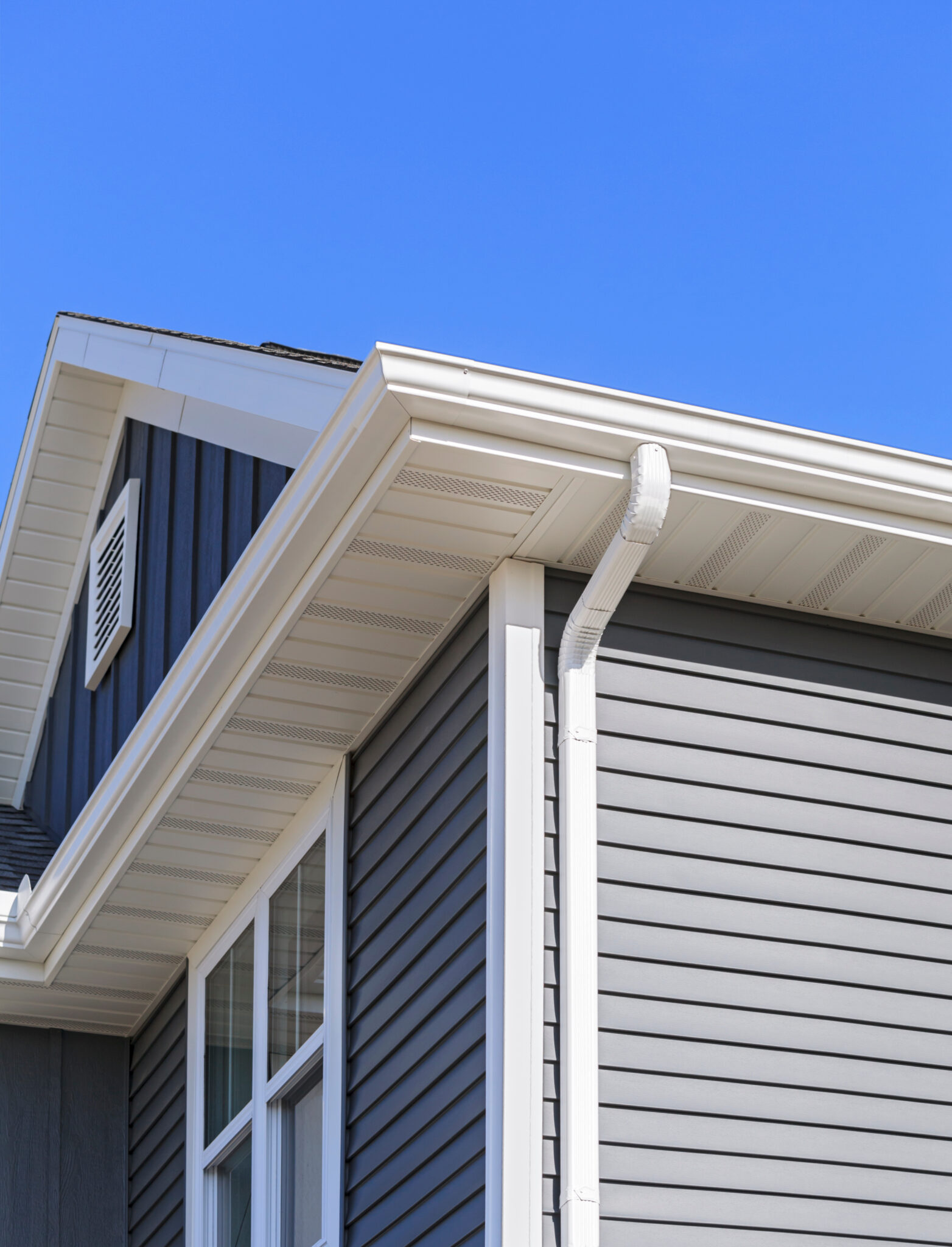 Grey siding, gutters, and soffit on a new home